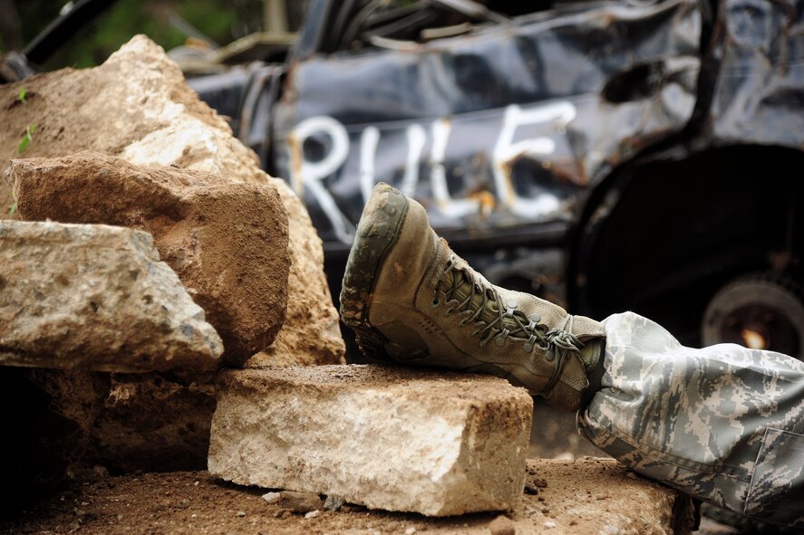 A simulated mortar attack victim positioned across the rubble during exercise Beverly Midnight 14-2 at Kunsan Air Base, Republic of Korea, July 17, 2014. The Operational Readiness Exercise assesses mission capabilities and ensures the Wolf Pack is in a constant state of readiness. (U.S. Air Force photo by Senior Airman Taylor Curry/Released) 