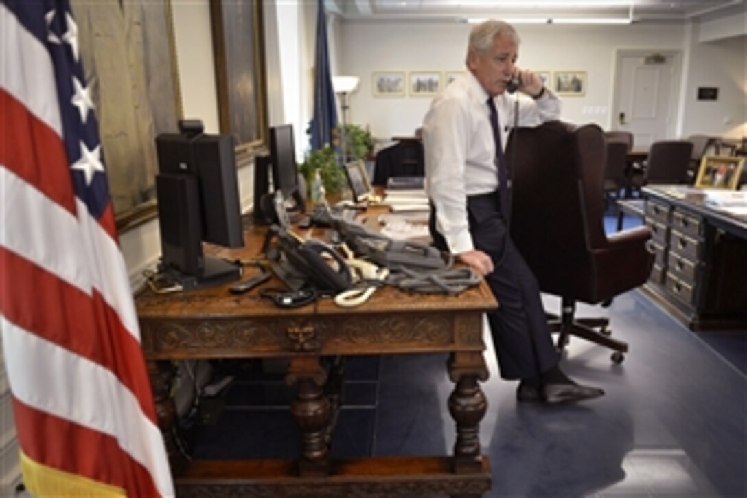 Defense Secretary Chuck Hagel speaks from his Pentagon office by phone with Malaysian Defense Minister Datuk Seri Hishammuddin Tun Hussein, July 18, 2014, to offer his condolences for those who lost their lives in the apparent downing of Malaysia Airlines Flight 17 as it flew over eastern Ukraine.