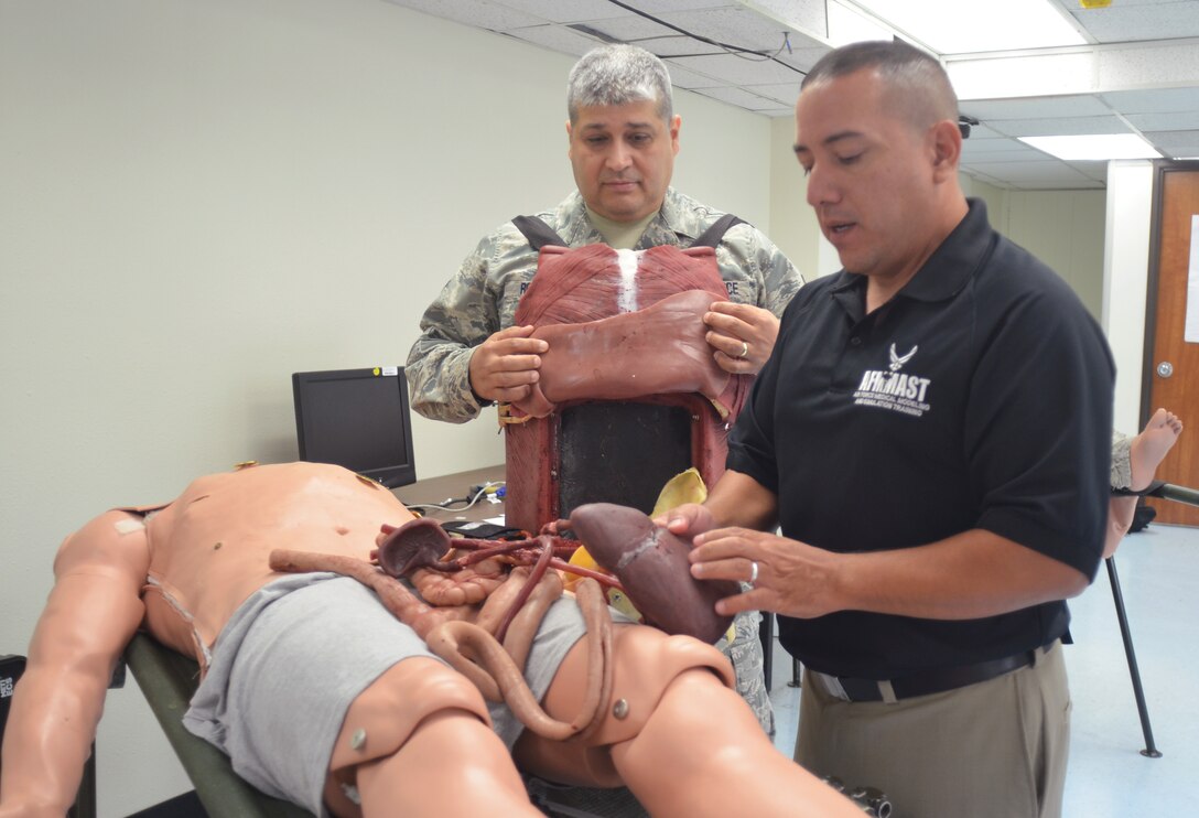 Senior Master Sgt. Juan Rodriguez, Air Force Medical Modeling and Simulation Training Program Manager, Air Education and Training Command, Joint Base San Antonio-Randolph, Texas, and Tony Garcia, Simulation Operator, Medical Research Training Center, Camp Bullis, Texas, break down the internal organs found in the Tactical Combat Casualty Care Cut Suit. 
The cut suit can be worn on a human or simulator to replicate severe traumatic situations for medical training environments.
