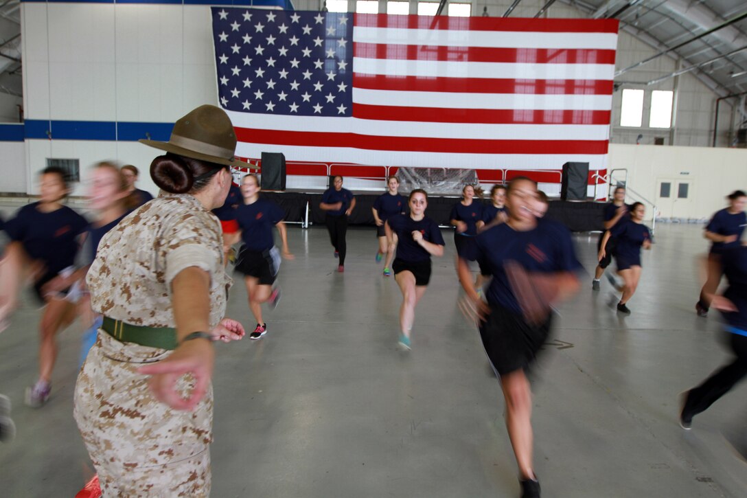 Sgt. Mallory Ortiz, a drill instructor from Marine Corps Recruit Depot Parris Island, S.C., teaches Female Poolees, women currently enrolled in the Marine Corps’ Delayed Entry Program, how to get into formation on Westover Air Reserve Base, July 19. The Poolees spent the day conducting an Initial Strength Test and learning drill. (Official Marine Corps Photo by Sgt. Richard Blumenstein)