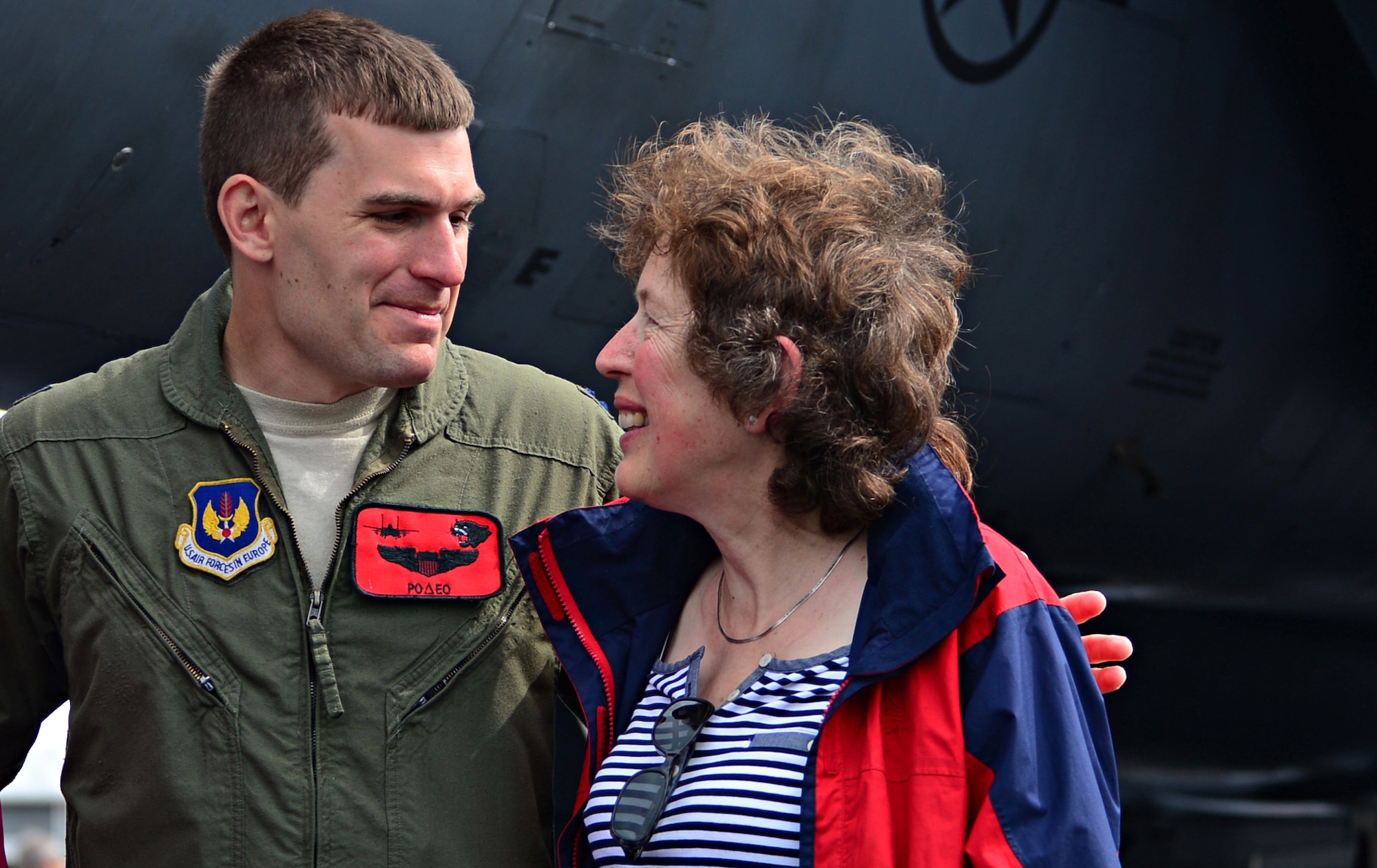 Capt. Tom Meyers, 494th Fighter Squadron F-15E Strike Eagle instructor pilot, speaks with a spectator about the aircraft during a public access showing at Farnborough International Airshow, England, July 19, 2014. The presence of military aircraft and their crew demonstrate U.S. industry ability to produce the type of equipment critical to the success of current and future military operations. (U.S. Air Force photo by Airman 1st Class Erin O'Shea/Released)