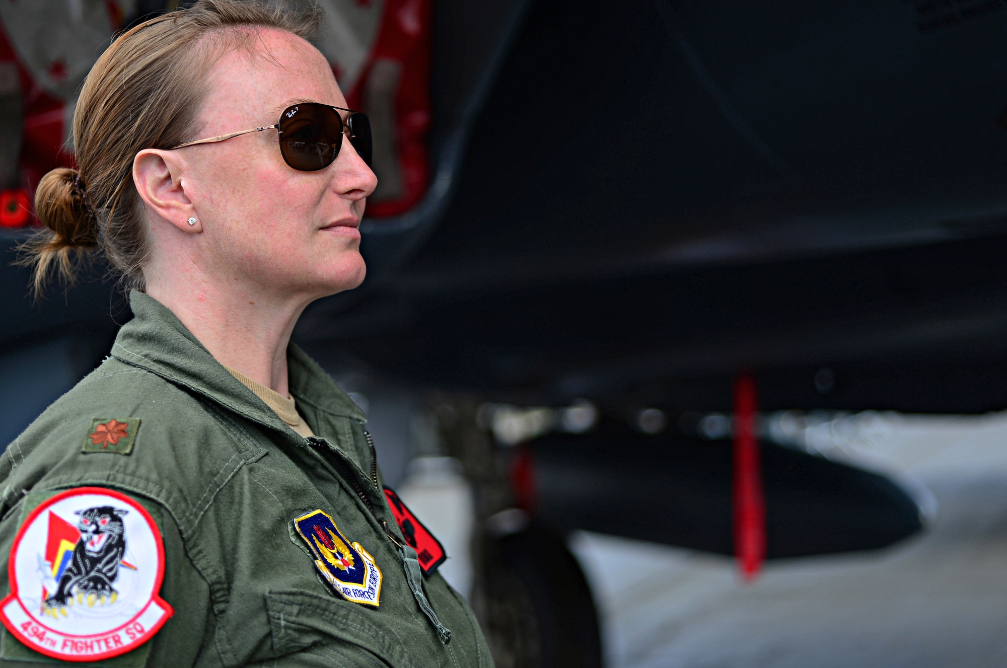 Maj. Claire Lundberg, 494th Fighter Squadron F-15E Strike Eagle weapons systems officer, stands in front of an F-15E Strike Eagle at Farnborough International Airshow, England, July 18, 2014. By participating in this U.K.-sponsored event, the U.S. demonstrates partnership and strong ties with the U.K., NATO, and Europe. (U.S. Air Force photo by Airman 1st Class Erin O'Shea/Released)