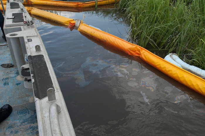 JOINT BASE CHARLESTON, S.C. - Jet fuel gathers along a “boom” July 18, 2014, at a cleanup site where a drainage ditch enters the Ashley River. A multi-pronged team comprised of base civil engineers and members of the Environmental Protection Agency, the U.S. Coast Guard, Department of Health and Environmental Control and Moran Environmental Recovery are working to remove the fuel, which traveled from the Air Base during a leak July 16. Most of the fuel gathered, and is being collected, upstream along the drainage ditch. An inspection of the Ashley River boom July 19 revealed no further fuel collection or pooling. (U.S. Air Force photo/Staff Sgt. William O'Brien)

