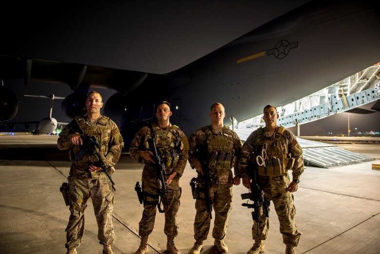 Airmen from the 386th Expeditionary Security Forces Squadron fly away security team prepare for a mission on a U.S. Air Force C-17 Globemaster III June 29, 2014 at an undisclosed location in Southwest Asia. The Airmen are deployed from around the country in support of Operation Enduring Freedom (U.S. Air Force photo by Staff Sgt. Jeremy Bowcock)