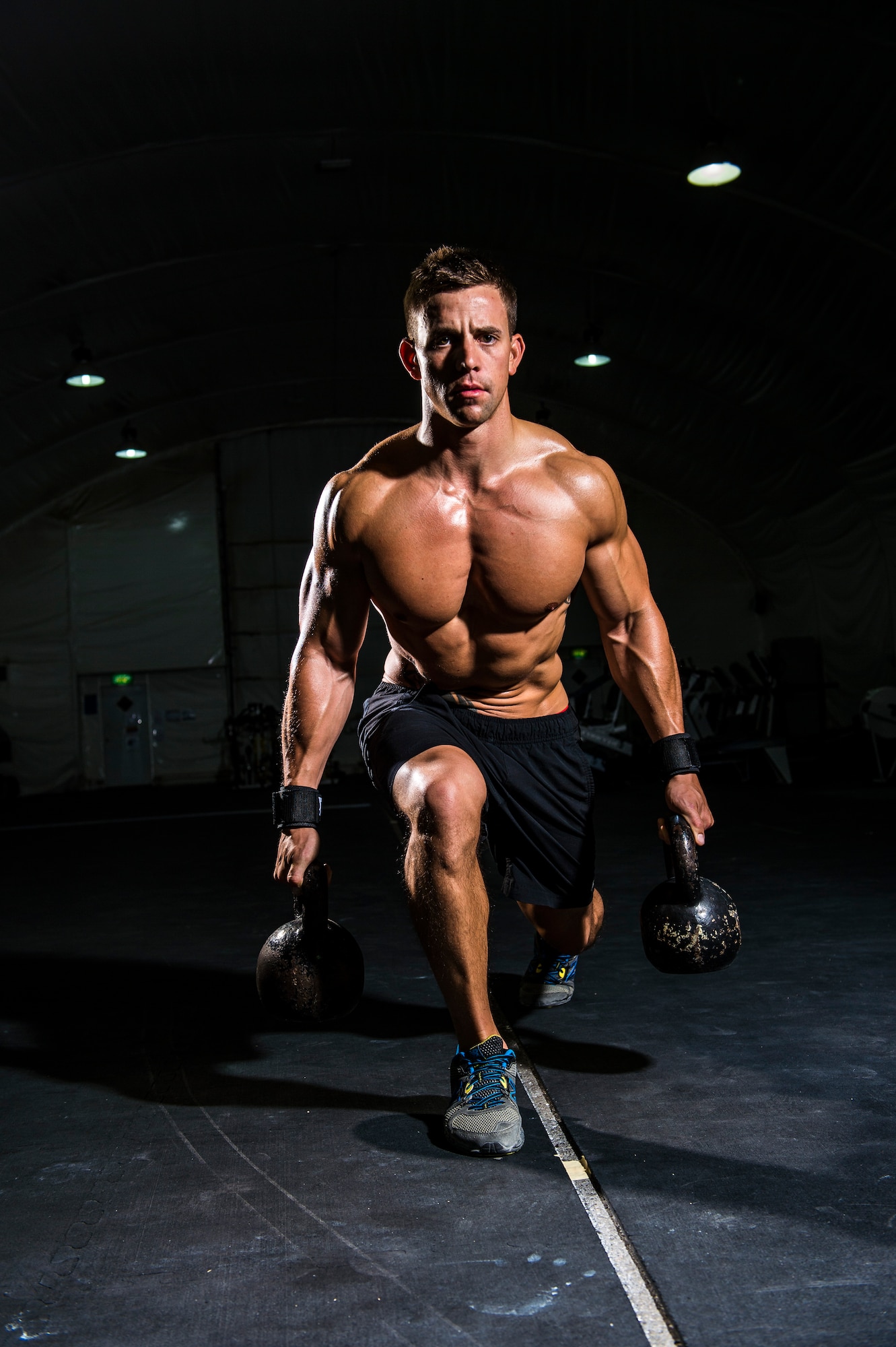 U.S Air Force Staff Sgt. Jesse Galvan, 386th Expeditionary Security Forces Squadron military working dog handler, works out at the fit tent July 10, 2014 at an undisclosed location in Southwest Asia. Galvan, an eight-year Air Force veteran, will be featured in Men’s Fitness Magazine along with his workout routine. (U.S. Air Force photo by Staff Sgt. Jeremy Bowcock)