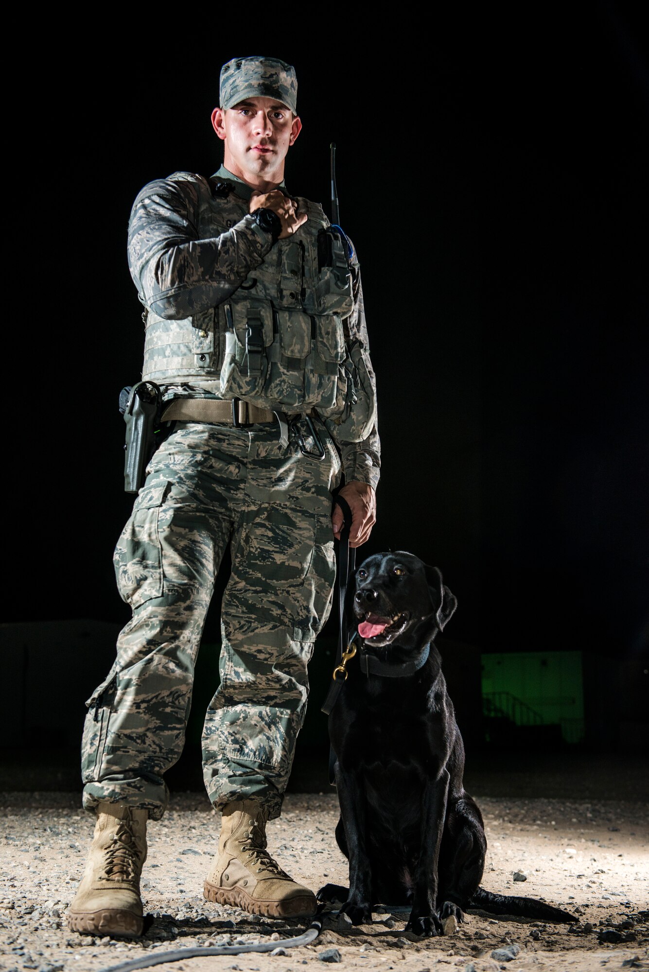 U.S Air Force Staff Sgt. Jesse Galvan, 386th Expeditionary Security Forces Squadron military working dog handler, poses with his dog, Ritz, July 16, 2014 at an undisclosed location in Southwest Asia. Galvan has been partnered with Ritz for two and a half years and deployed twice with her. The Dallas-Ft. Worth native deployed here from Tinker Air Force Base, Oklahoma in support of Operation Enduring Freedom. (U.S. Air Force photo by Staff Sgt. Jeremy Bowcock)