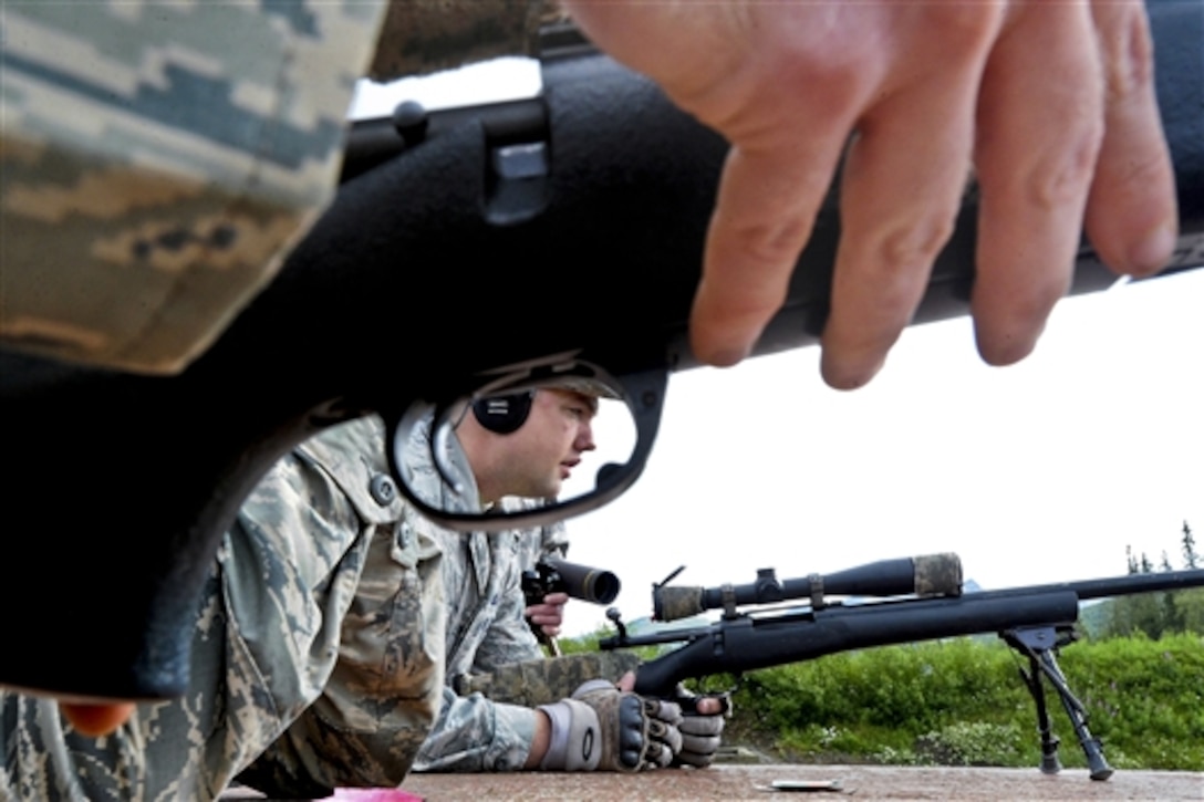 Air Force Staff Sgt. Ryan Link, center, prepares to fire his weapon while training with the M24 Sniper Weapon System on Joint Base Elmendorf-Richardson, Alaska, July 11, 2014. Link is assigned to the 673rd Security Forces Squadron. 