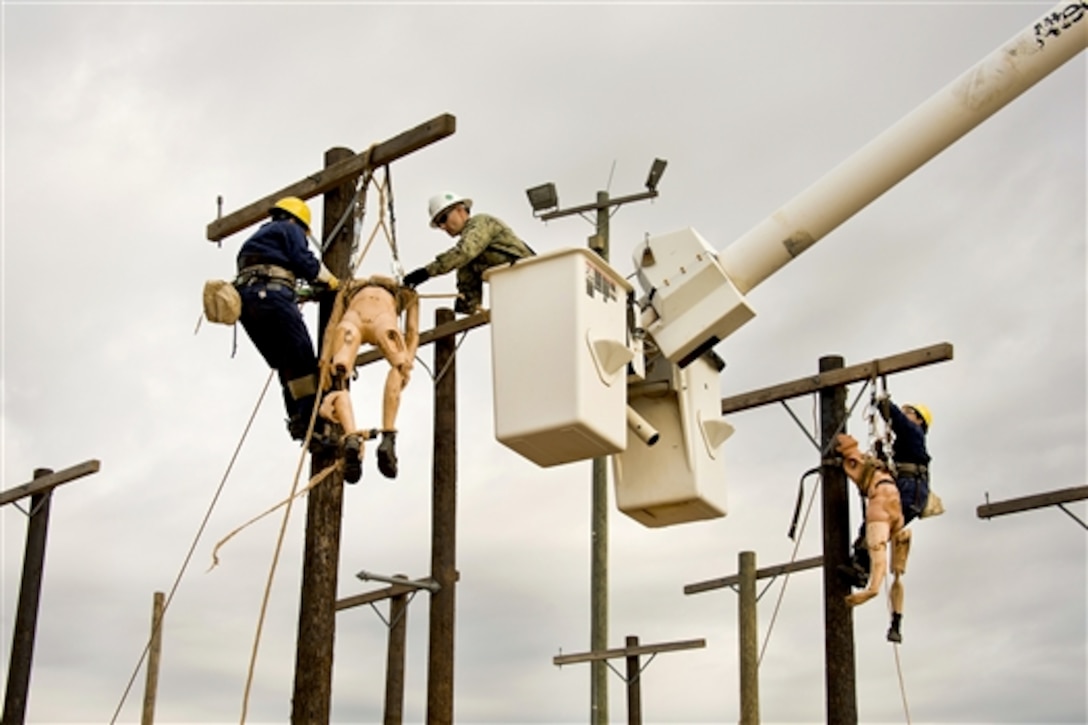 Navy Petty Officer 2nd Class Joshua Guerreiro performs pole top rescue procedures for the Navy Seabee Construction Electrician "A" school on Sheppard Air Force Base, Texas, July 15, 2014. The pole top rescue qualification simulates a climber who has been injured and students who provide assistance. Guerreiro is a Navy Unique Block 7 instructor assigned to the 366th Training Squadron. 