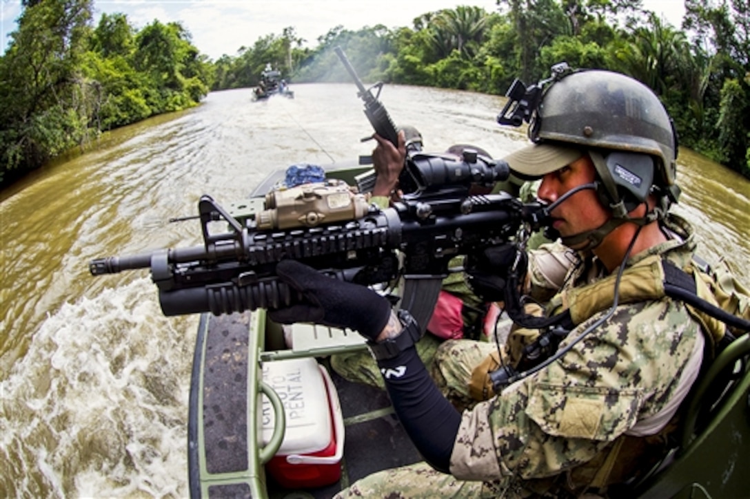 U.S. Navy Petty Officer 2nd Class Michael Galla trains with the Belize Special Boat Unit during Southern Partnership Station 2014 on the Moho River, Belize, July 8, 2014. Southern Partnership is a U.S. Navy deployment focused on expert exchanges with partner nation militaries and security forces. Galla is a gunner's mate assigned to Coastal Riverine Squadron 2. 