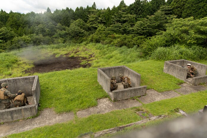Combat Logistics Company 36 Marines and augments take shelter in the pits of a grenade range as an M67 hand grenade explodes during Exercise Dragon Fire 2014 at Combined Arms Training Center Camp Fuji, Japan, July 12. Dragon Fire, held by CLC-36, allows service members to conduct infantry training in a field environment.