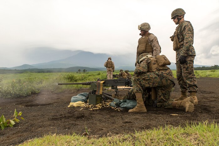 Lance Cpl. James Cohen, an expeditionary airfield technician with Headquarters and Headquarters Squadron, augmented with Combat Logistics Company 36, fires an M2 heavy machine gun as part of his crew served weapons training during Exercise Dragon Fire 2014 at Combined Arms Combat Training Center Camp Fuji, Japan, July 13. The M2 fires .50 caliber rounds at a rate of 635 rounds per minute. Service members also fired the M249 Light Machine Gun, M240G medium machine gun and Mark 19 grenade launcher.