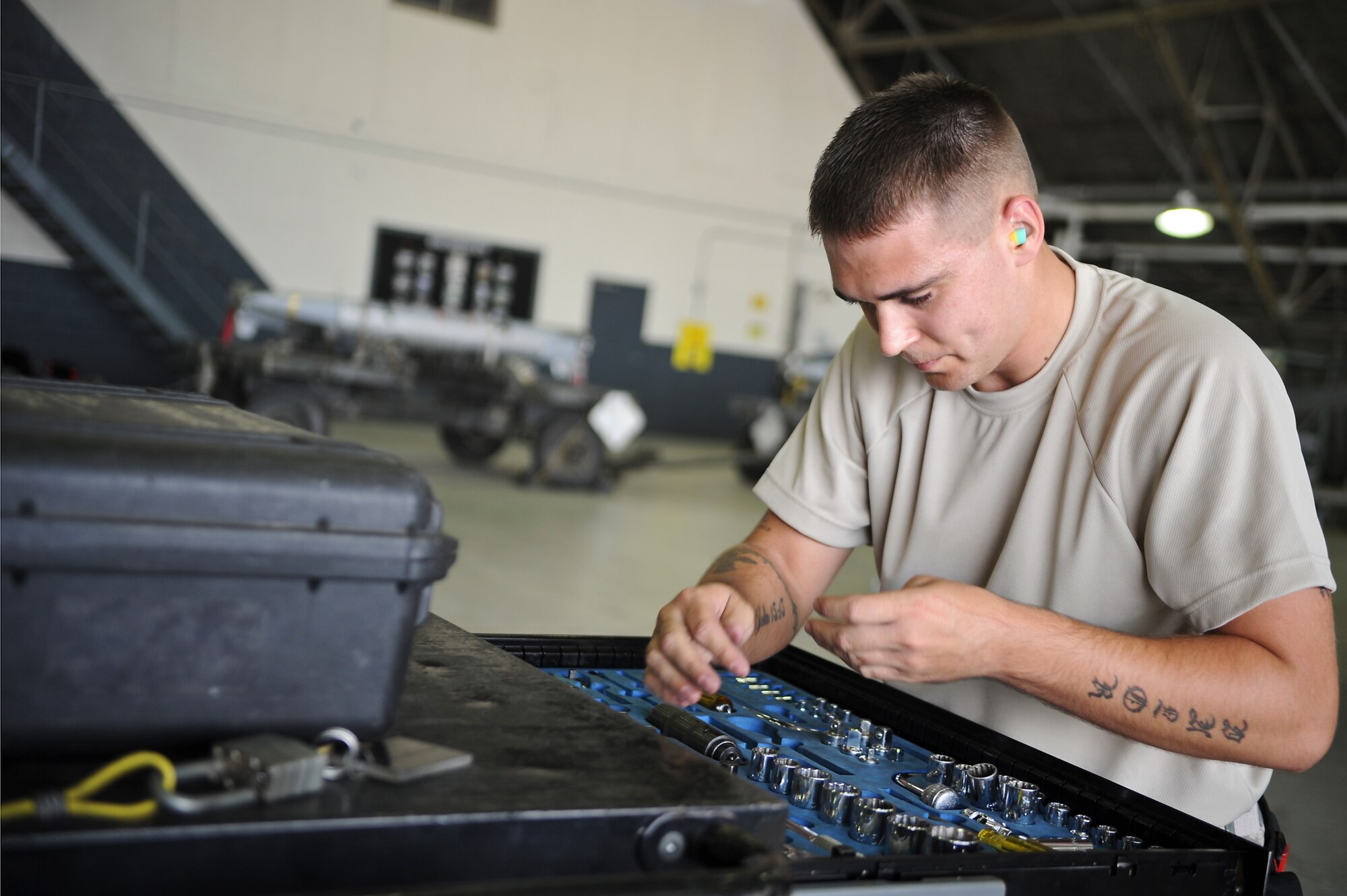 Senior Airman Justin Grider, 36th Aircraft Maintenance Unit weapons load crew member, puts away tools during a quarterly load crew competition on Osan Air Base, Republic of Korea, July 18, 2014. As part of the competition, Airmen are inspected on their dress and appearance and given a written examination. (U.S. Air Force photo/Senior Airman Matthew Lancaster)