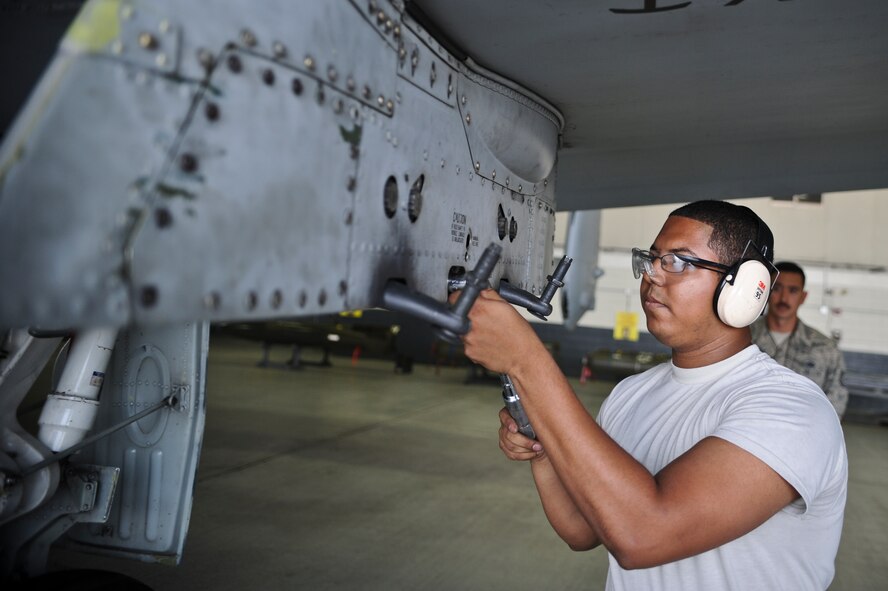 Senior Airman Antonio Chavez, 25th Aircraft Maintenance Unit weapons load crew member, prepares an A-10 Thunderbolt II to be loaded with munitions during a quarterly load crew competition on Osan Air Base, Republic of Korea, July 18, 2014. During the competition the Airmen are evaluated on safety, reliability and technical errors. (U.S. Air Force photo/Senior Airman Matthew Lancaster)