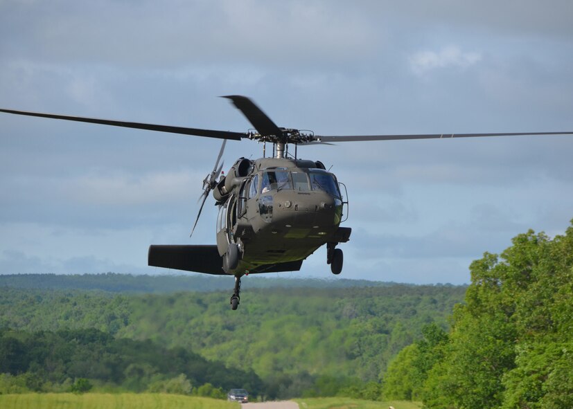 Maj. Tim Sullivan, a pilot with the Missouri Air National Guard’s 131st Bomb Wing, prepares himself for the drop-off while aboard the Missouri Army National Guard’s 1-135th Aviation Battalion UH-60 Blackhawk helicopter during a training exercise at Cannon Range-Laquey, Missouri, on May 28, 2014. Sullivan and two other pilots from Whiteman Air Force Base, Missouri, participated in the realistic training mission that forced the pilots to use the training they have received throughout their careers to evade simulated captors. (U.S. Air National Guard photo by Senior Master Sgt. Mary-Dale Amison/RELEASED)