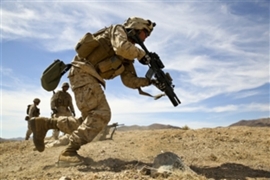 A Marine sprints to his next position during a live-fire exercise at the Army National Training Center on Fort Irwin, Calif., July 13, 2014. The Marine is assigned to Foxtrot Company, 4th Light Armored Reconnaissance Battalion. The Marines completed numerous live-fire exercises and tested the capabilities of companies within the battalion.