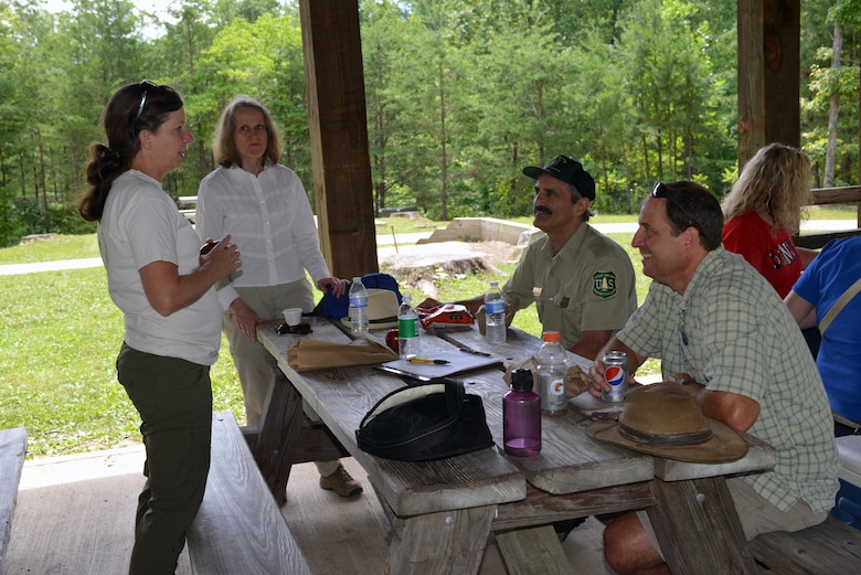 Valarie McCormack, an archaeologist with the U.S. Army Corps of Engineers Nashville District (left) talks with a team of facilitators from the University of Kentucky, Kentucky Archaeological survey and the Bureau of Land Management to educate local school teachers about archaeological history and preservation at the Natural Arch in the Daniel Boone National park July 17.