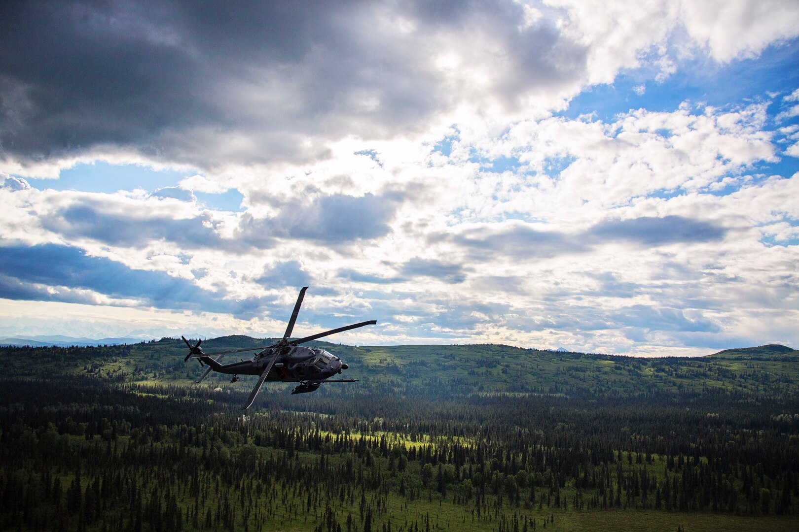An Alaska Air National Guard HH-60 Pave Hawk helicopter from the 210th Rescue Squadron flies on a training flight July 10 in south-central Alaska. The hoist capabilities of the Pave Hawk helicopters provide the rescue assets with the ability to conduct rescue missions in rugged terrain. 