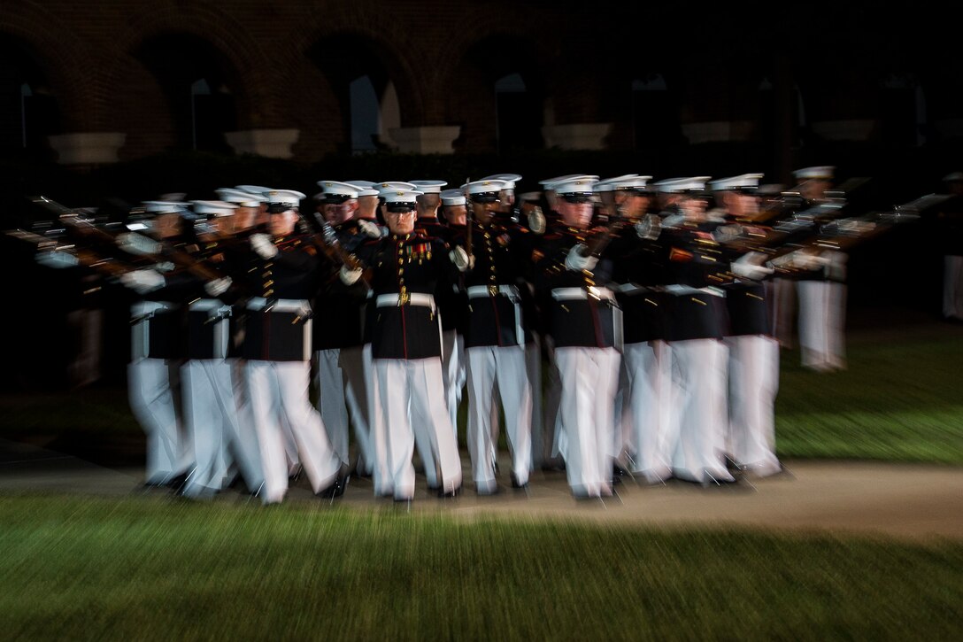 The U.S. Marine Corps Silent Drill Platoon performs during a Friday Evening Parade at Marine Barracks Washington, D.C., July 18, 2014. (Official Marine Corps photo by Cpl. Dan Hosack/Released)