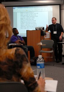 Dario DiBattista, a Marine veteran and instructor with the Veterans Writing Project, guides a seminar discussion on war poetry.