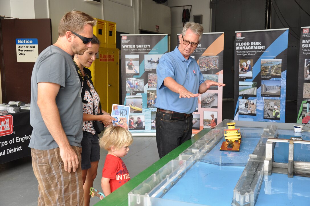 Kevin Bokay, right, explains to visitors how locks operate on the Mississippi River. An open house was held at Lock and Dam 1, Saturday, July 19.