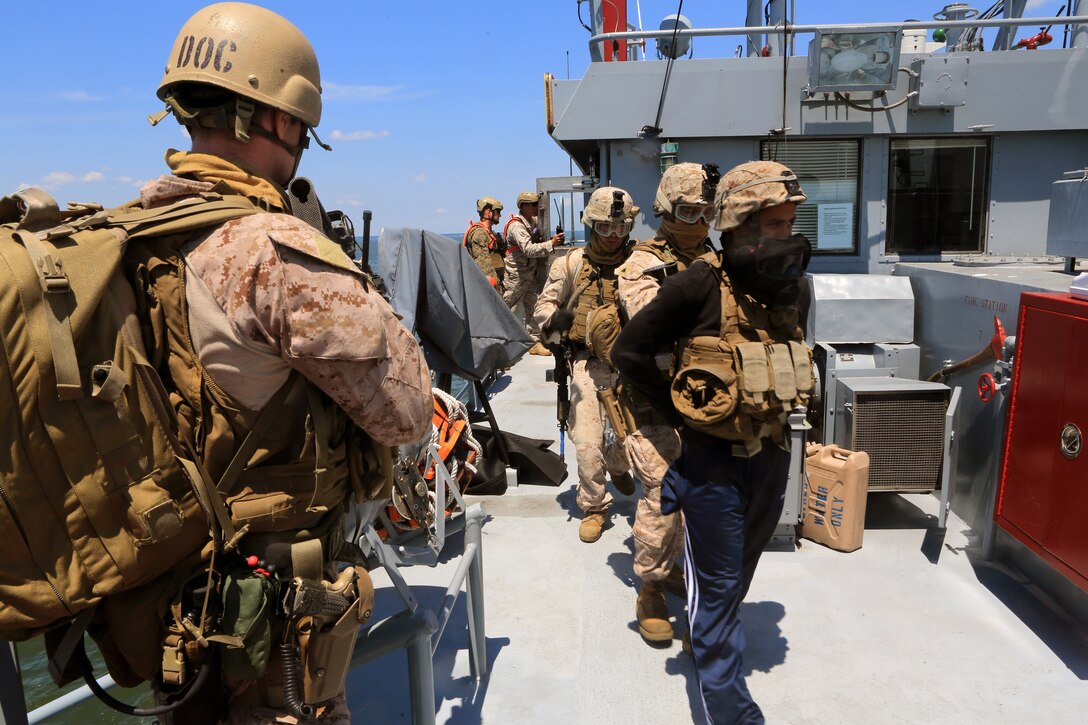 Marines with the 24th Marine Expeditionary Unit’s Maritime Raid Force escort a simulated detainee during a Visit, Board, Search, and Seizure exercise at Joint Base Langley-Eustis, Va., July 17, 2014. The exercise was part of Realistic Urban Training, the 24th MEU’s first major pre-deployment training exercise in preparation for their deployment at the end of the year. The MRF is a contingent of Marines from Force Reconnaissance Company, 2nd Reconnaissance Battalion. (U.S. Marine Corps photo by Cpl. Devin Nichols)