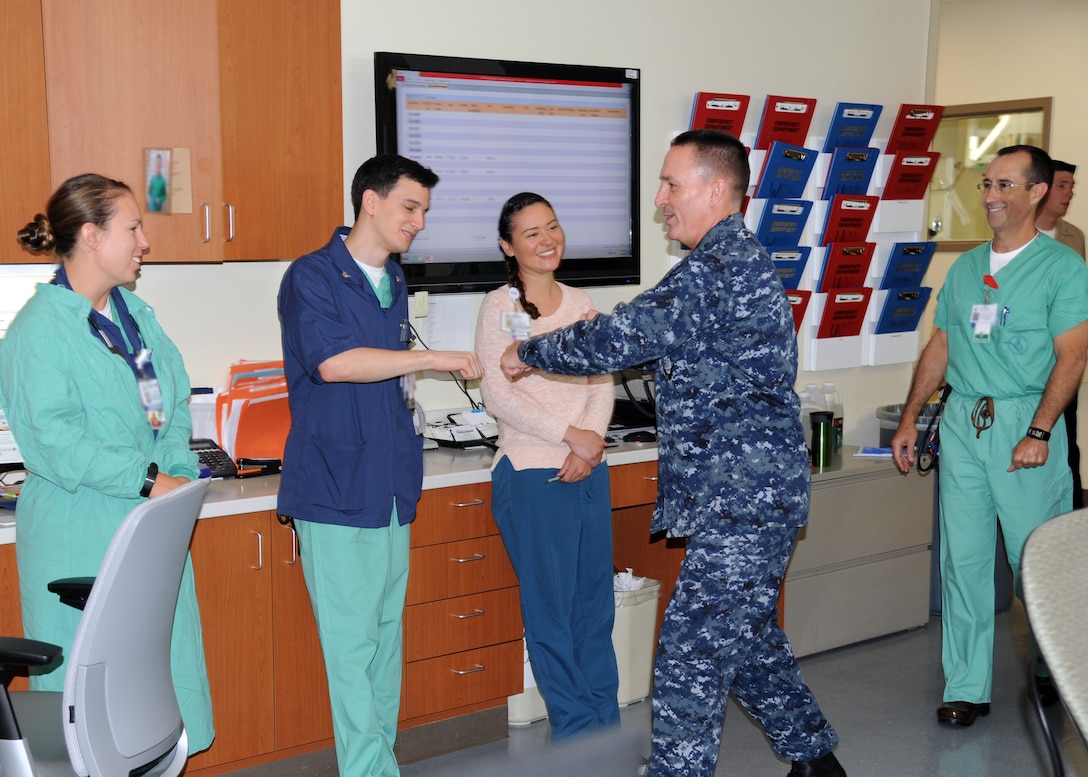 Master Chief Petty Officer of the Navy Mike Stevens greets staff members of the Naval Hospital Camp Pendleton Emergency Department with “fist bumps” during a hospital tour July 18.  This is the second visit to the command since Stevens became MCPON, but the first time since the new four-story, 500,000 square-foot hospital opened in Dec. 2013.  Stevens mainly talked to the junior sailors; asking them about their careers and plans for the future.  While here, he visited the galley, emergency department, physical/occupational therapy clinic, simulation laboratory and the multi-service in-patient ward. 