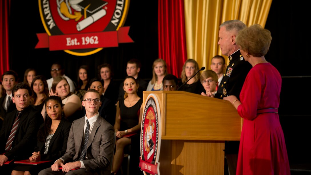 Commandant of the Marine Corps Gen. James F. Amos and his wife Bonnie address scholarship recipients during the Marine Corps Scholarship Foundation announcement ceremony hosted at the Ronald Reagan building in Washington, July 15, 2014. Since 1962 the Marine Corps Scholarship Foundation has awarded more than 30,00 scholarships valued at more than 90 million dollars.
