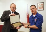 Grzegorz Olszak, Polish ambassador to the State of Kuwait and the Kingdom of Bahrain, left, presents a token of appreciation to Col. Drew Dukett, commander of the 108th Sustainment Brigade July 14, 2014, at the Polish Embassy of Kuwait.