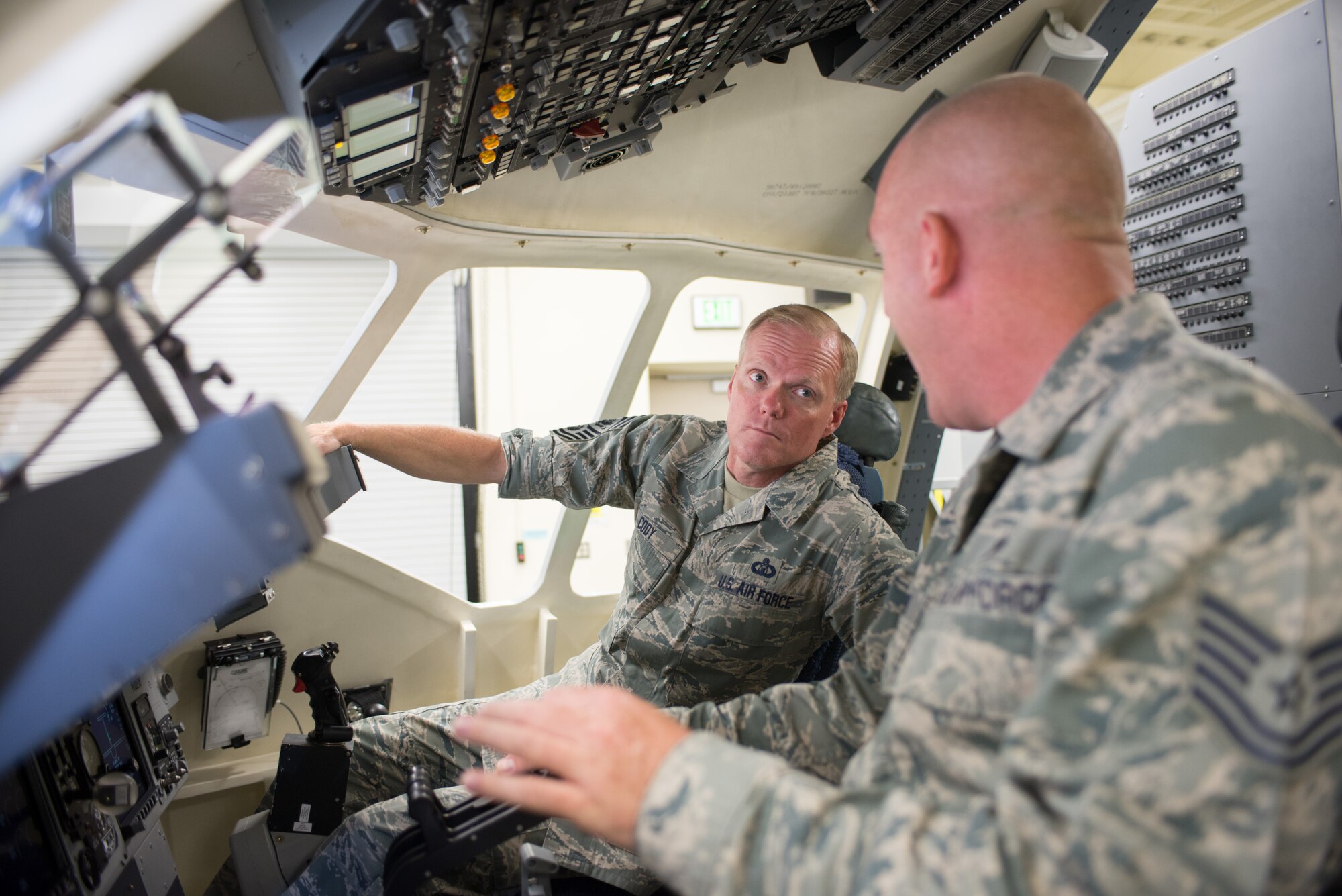 Tech Sgt. Kenneth Kent, right, shows Chief Master Sergeant of the Air Force James A. Cody the inside of a C-17 Globemaster III simulator July 10, 2014, on Travis Air Force Base, Calif. During his tour of the 60th Air Mobility Wing, 621st Contingency Response Wing and the 349th Air Mobility Wing, Cody discussed improvements of the enlisted performance report, and the important role of frontline supervisors have in making the evaluation process one that helps all Airmen develop their potential. (U.S. Air Force photo/Ken Wright)