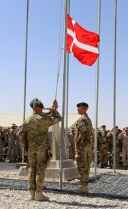 Danish soldiers, with the Danish Contingent International Security Assistance Force 17 (DANCON ISAF-17) to Afghanistan, participate in the Danish Flag Lowering ceremony aboard Camp Leatherneck, Helmand province, Afghanistan, July 21, 2014. The lowering of the Danish Flag over Camp Leatherneck formally concludes the country's participation in Regional Command (Southwest). (Official U.S. Marine Corps photo by Sgt. James D. Pauly, Marine Expeditionary Brigade Afghanistan/Released)