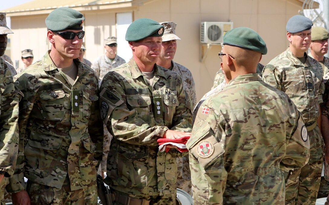 Danish soldiers, with the Danish Contingent International Security Assistance Force 17 (DANCON ISAF-17) to Afghanistan, participate in the Danish Flag Lowering ceremony aboard Camp Leatherneck, Helmand province, Afghanistan, July 21, 2014. The lowering of the Danish Flag over Camp Leatherneck formally concludes the country's participation in Regional Command (Southwest). (Official U.S. Marine Corps photo by Sgt. James D. Pauly, Marine Expeditionary Brigade Afghanistan/Released)