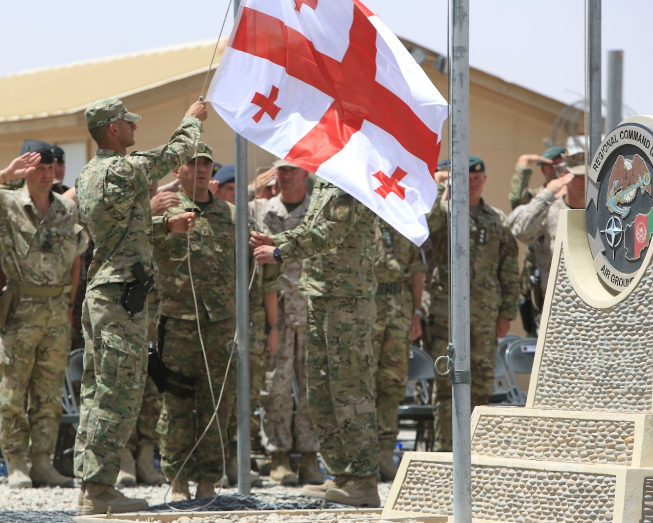 Georgian soldiers, with the Georgian contingent to Afghanistan, participate in the Georgian Flag Lowering ceremony aboard Camp Leatherneck, Helmand province, Afghanistan, July 15, 2014. The lowering of the Georgian Flag over Camp Leatherneck formally concludes the country's participation in Regional Command (Southwest), since 2004. (Official U.S. Marine Corps photo by Sgt. Dustin D. March/Released)