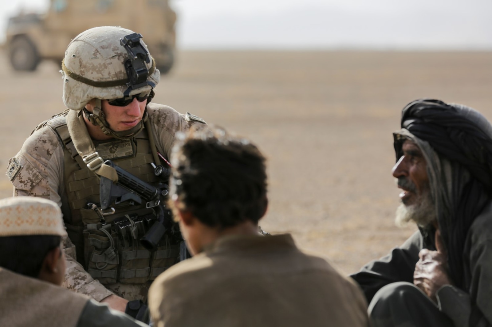 U.S. Marine Cpl. Justin Hinckley, a team leader with Weapons Company, 1st Battalion, 2d Marine Regiment, talks to a local family of the Washer district during a security patrol in Helmand province, Afghanistan on July 16, 2014. Patrols are conducted to disrupt enemy operations against Bastion- Leatherneck Complex. (Official U.S. Marine Corps photo by Cpl. John A. Martinez Jr. / Released)
