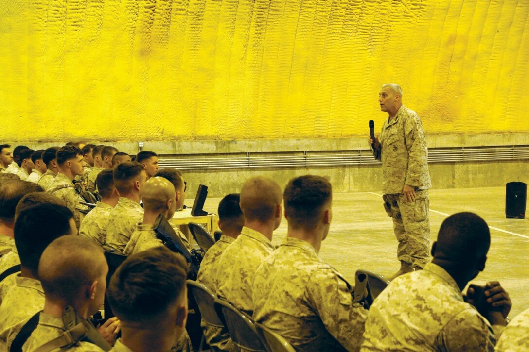 Assistant Commandant of the Marine Corps Gen. John M. Paxton Jr. speaks to Marines and sailors during a town hall meeting aboard Camp Leatherneck, Helmand province, Afghanistan, July 18, 2014. During the meeting, Gen. Paxton discussed the restructuring of the Corps, how Marines will reset into peacetime as a crisis response force, as well as the integration of women into ground combat jobs.