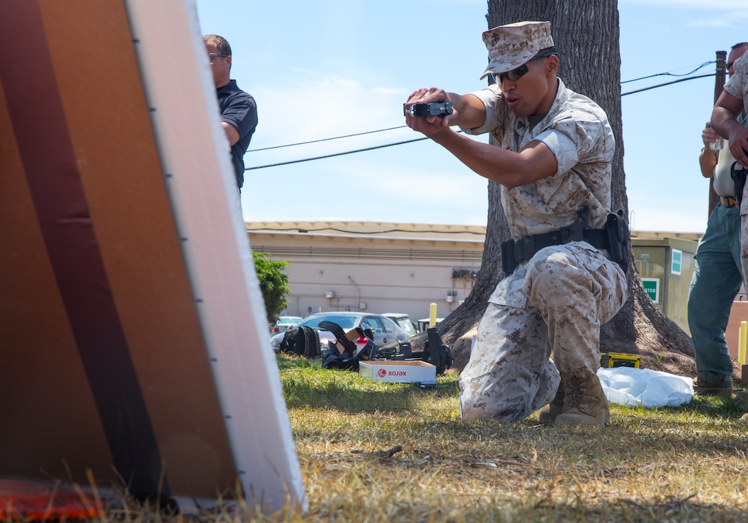 Cpl. Vettel Arnold, military police officer with the special reaction team aboard Marine Corps Air Station Miramar, Calif., practices aiming a Taser X26 during annual Taser training aboard the air station, July 18. This training provides a nonlethal alternative to controlling a situation. 