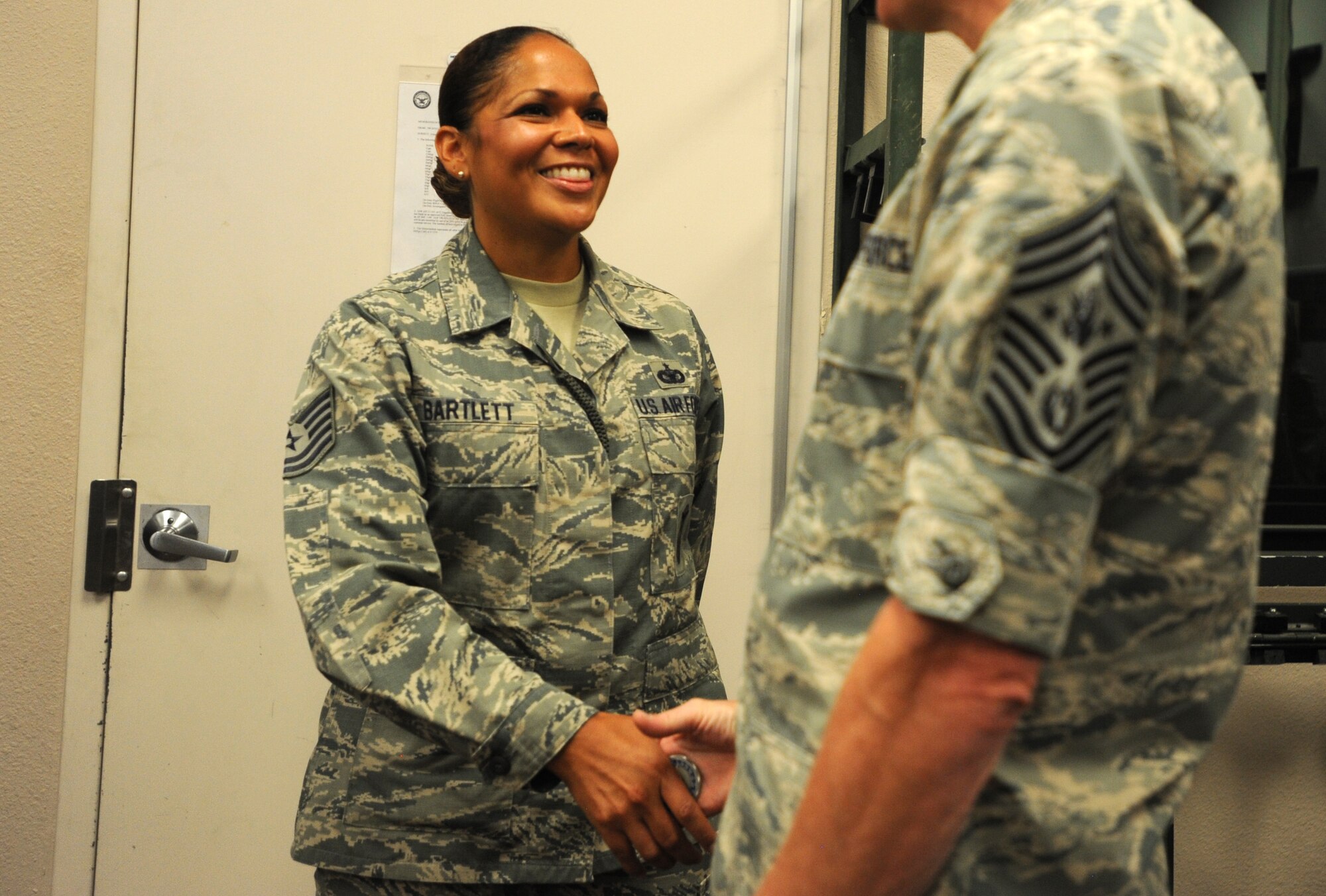 Tech. Sgt. Tracie Bartlett, 799th Security Forces Squadron, commander support staff non-commissioned officer in charge, is coined by Chief Master Sgt. of the Air Force James Cody for her exceptional performance as an interim first sergeant and her involvement around her unit and community at Creech Air Force Base, Nev., July 16, 2014. Cody also reassured the 799th Air Base Group that their contributions to the 432nd Wing and its mission directly impact remotely piloted aircraft operations around the globe. (U.S. Air Force photo by Tech. Sgt. Nadine Barclay/RELEASED)