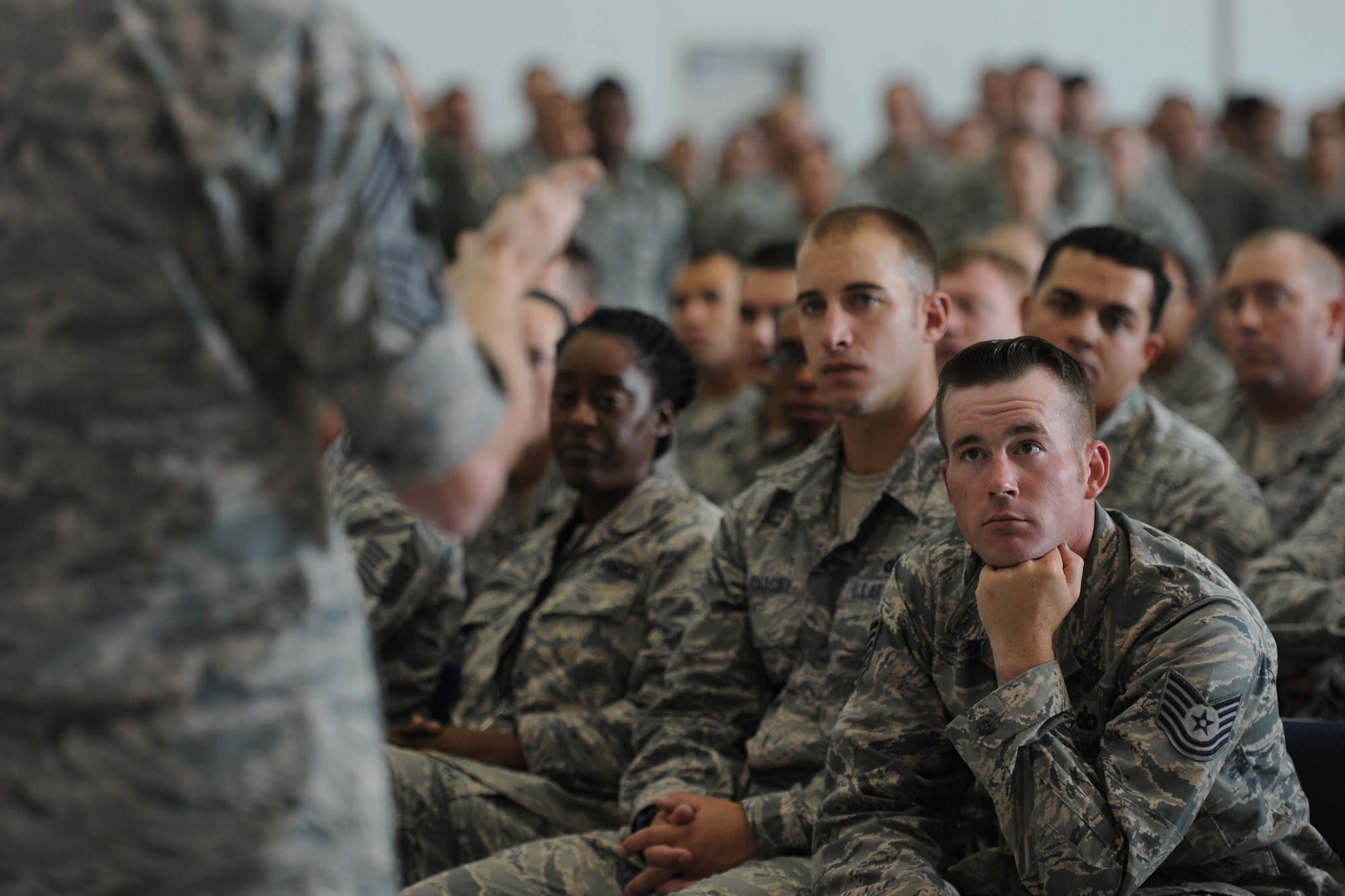 Airmen listen as Chief Master Sgt. of the Air Force James Cody delivers his enlisted perspective to the Airmen of the 432nd Wing/432nd Air Expeditionary Wing and 799th Air Base Group during an Airman’s Call at Creech Air Force Base, Nev., July 16, 2014. During his visit, Cody saw firsthand the operations tempo of the base’s Airmen.  Everyday Creech Airmen fulfill their mission by providing intelligence, surveillance and reconnaissance, maintenance, base support and defense, and other capabilities in support of combatant commanders around the globe. (U.S. Air Force photo by Tech. Sgt. Nadine Barclay/RELEASED)