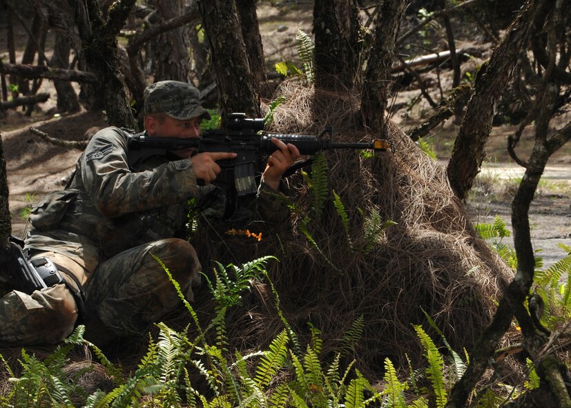 Senior Airman Brian Walker, Pacific Regional Training Center Commando Warrior student from the 354th Security Forces Squadron at Eielson Air Force Base, Alaska, prepares to fire his weapon during dismounted tactics training July 16, 2014, on Andersen South, Guam. Cadre from the 736th Security Forces Squadron at Northwest Field, Guam, host the 17-day pre-deployment training for Pacific Air Forces defenders six to eight times per year. (U.S. Air Force photo by Senior Airman Cierra Presentado/Released)