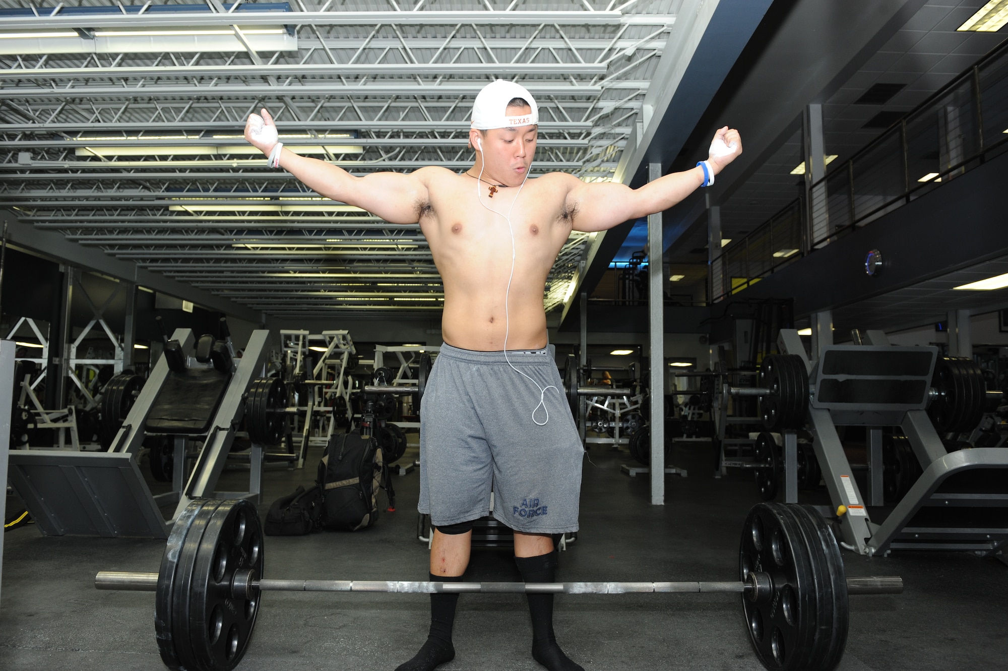 Airman 1st Class Benny Le, 22nd Security Forces Squadron patrolman, prepares to perform a deadlift exercise, July 15, 2014, at a fitness club in Wichita, Kan. Le is training for a powerlifting competition in August. (U.S. Air Force photo/Airman 1st Class David Bernal Del Agua)