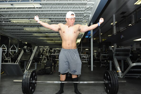 Airman 1st Class Benny Le, 22nd Security Forces Squadron patrolman, prepares to perform a deadlift exercise, July 15, 2014, at a fitness club in Wichita, Kansas. Le is training for a powerlifting competition in August. (U.S. Air Force photo/Airman 1st Class David Bernal Del Agua) 

