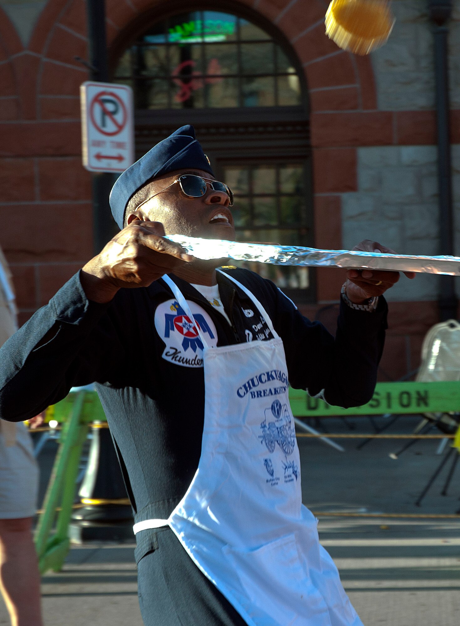 Maj. Darrick Lee, U.S. Air Force Thunderbirds Public Affairs officer, back peddles to catch a pancake during the annual pancake breakfast July 21 at the Cheyenne Depot Plaza. “Catchers” are responsible for running around and catching the pancakes as the chefs toss them into the air. (U.S. Air Force photo by Airman Malcolm Mayfield)