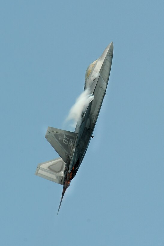 An F-22 Raptor soars through the skies at the 2014 Defenders of Freedom Open House and Air Show held July 19 at Offutt Air Force Base, Nebraska.  The F-22 Demo Team was one of the premier acts at the air show.  (U.S. Air Force photo by Josh Plueger/Released)