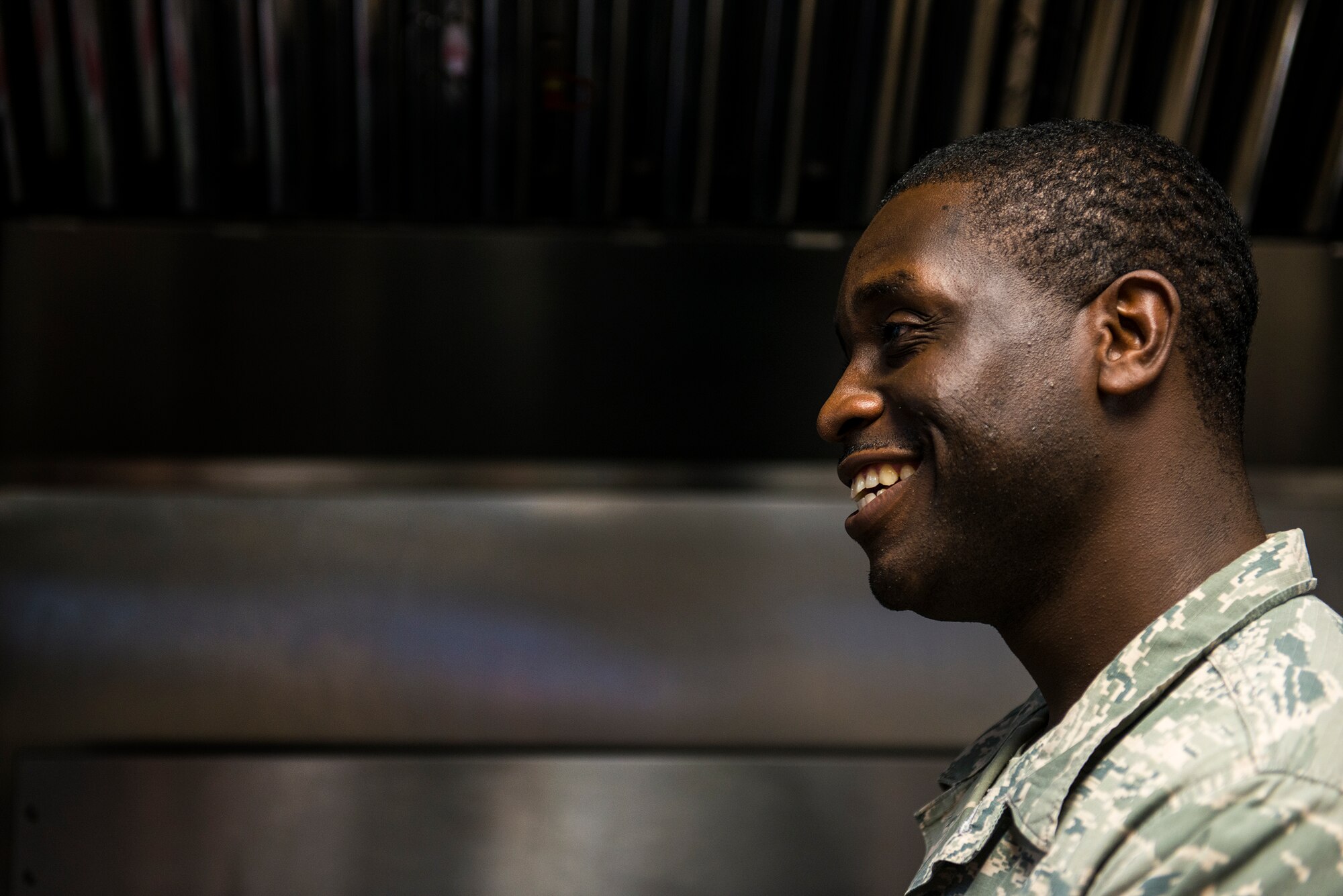U.S. Air Force Staff Sgt. Phillip Burns II, 23d Civil Engineer Squadron fire inspector, stops for a chat in front of a stove at Moody Air Force Base, Ga., July 17, 2014. Burns cooks at least four times per week for himself or anyone who asks. (U.S. Air Force photo by Airman 1st Class Ryan Callaghan/Released)