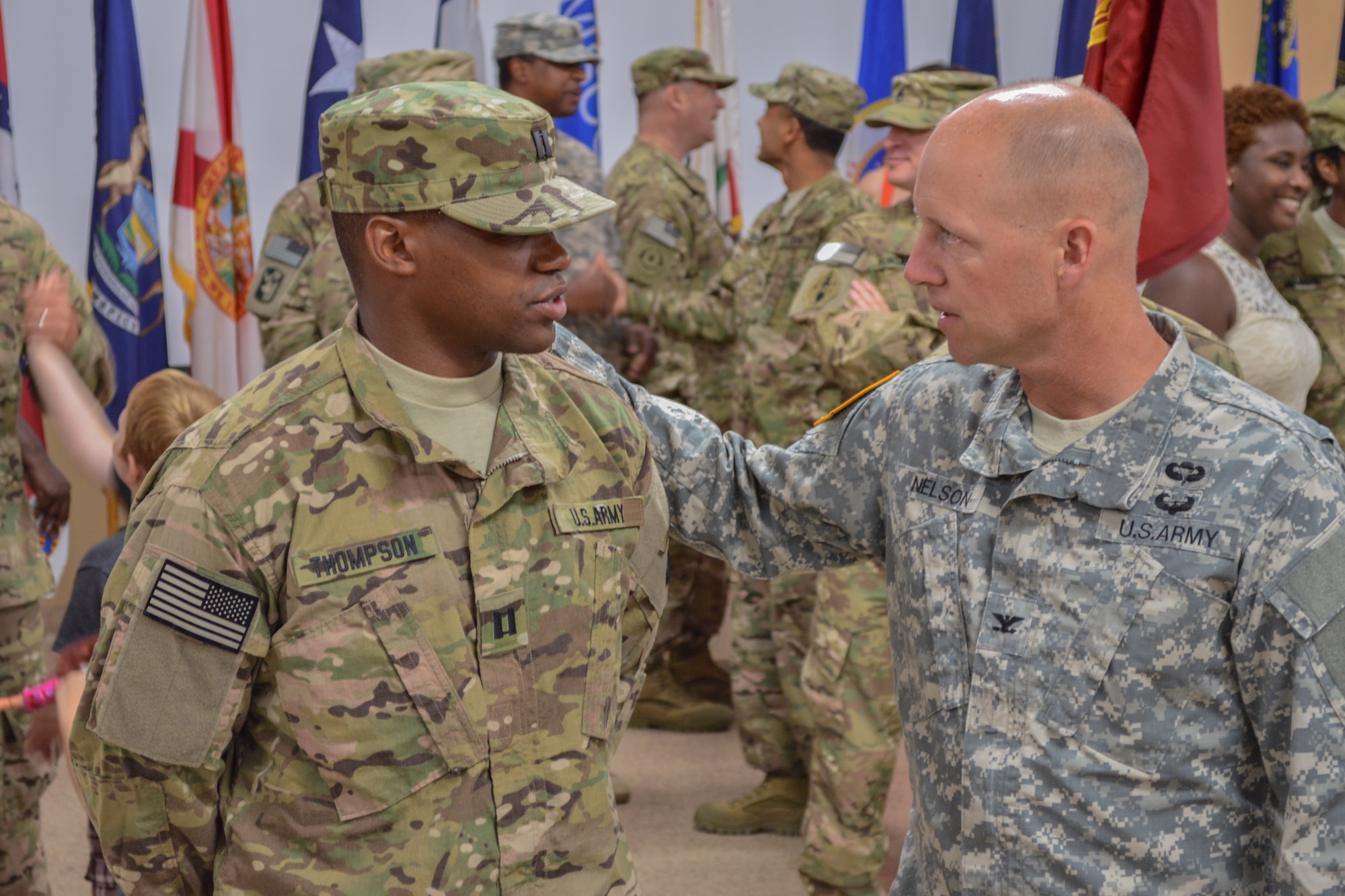 U.S. Army Col. Randal Nelson, 7th Transportation Brigade (Expeditionary) commander, speaks with Capt. Joseph Thompson during a deployment ceremony for the 612th Movement Control Team, 53rd Transportation Battalion, 7th Trans. Bde. (Ex.) at Fort Eustis, Va., July 19, 2014. Thompson deployed as part of a team to Afghanistan in support of Operation Enduring Freedom. (U.S. Army photo by Spc. Marian Alleva/Released)