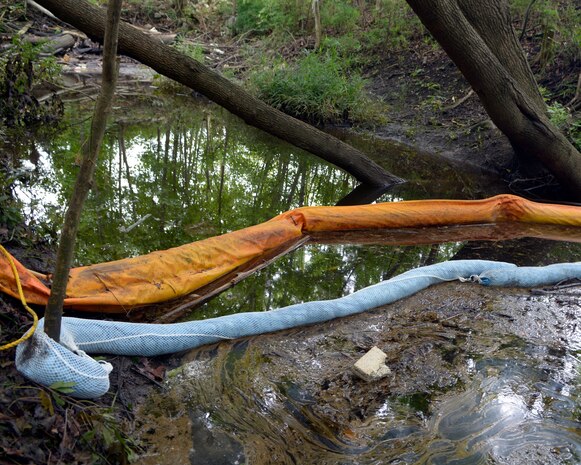 A “boom” traps fuel along the surface of a drainage ditch outside Joint Base Charleston – Air Base July 21, 2014. A multi-pronged team comprised of base civil engineers and members of the Environmental Protection Agency, the U.S. Coast Guard, Department of Health and Environmental Control and Moran Environmental Recovery have been working together to control and remove fuel spilled from the base July 16, 2014. EPA representatives returned to Atlanta July 21, due to marked improvement at the site. (U.S. Air Force Photo/ A1C Sydney Manning)