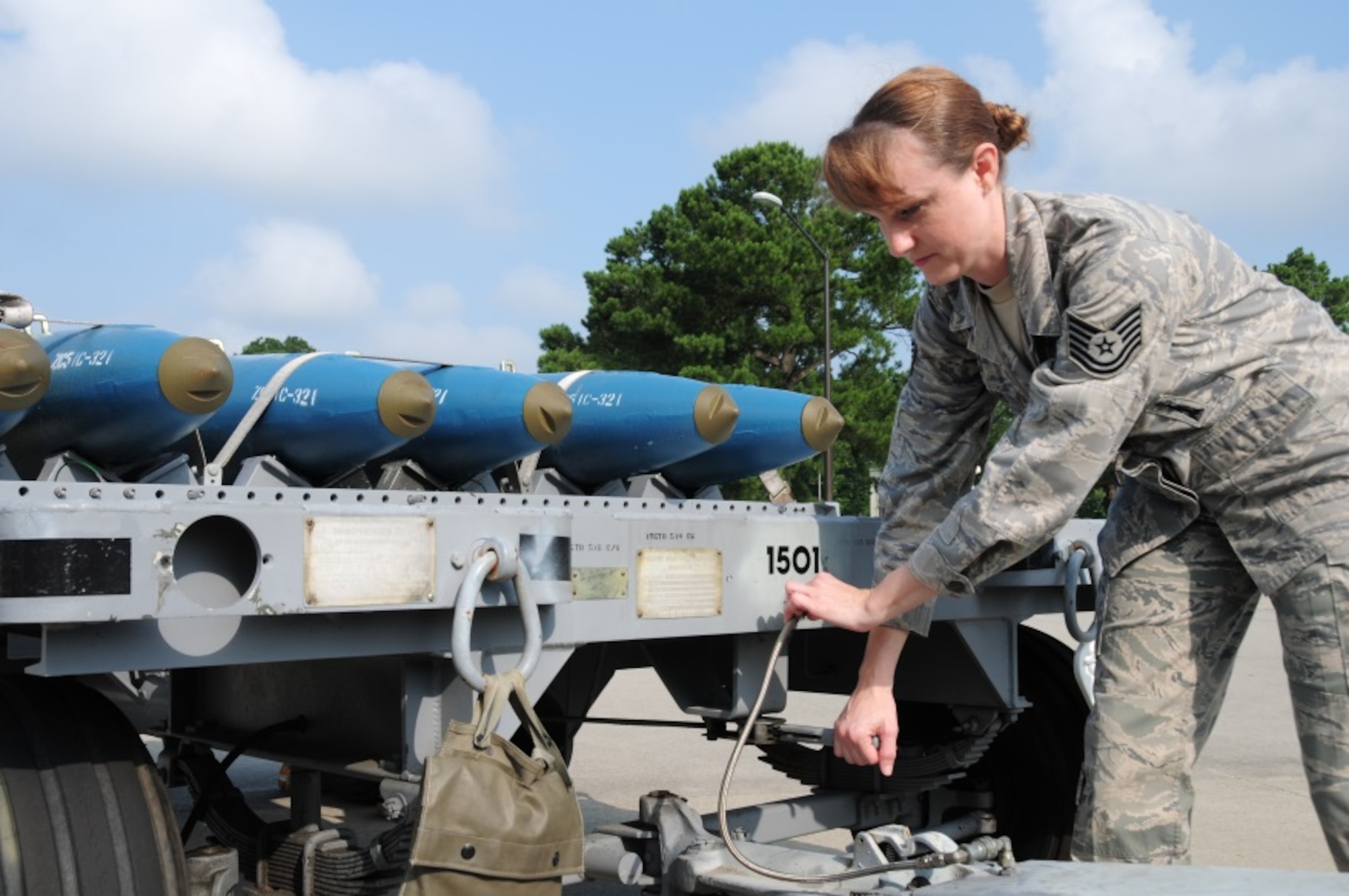 Tech Sgt. Victoria Hubbard, 414th Maintenance Squadron munitions technician, inspects trailers prior to transporting “practice bombs” onto the flightline at Seymour Johnson Air Force Base, July 12, 2014. Trailers must be properly configured to ensure safety when moving munitions. (U.S. Air Force photo by Staff Sgt. Lausanne Kinder)