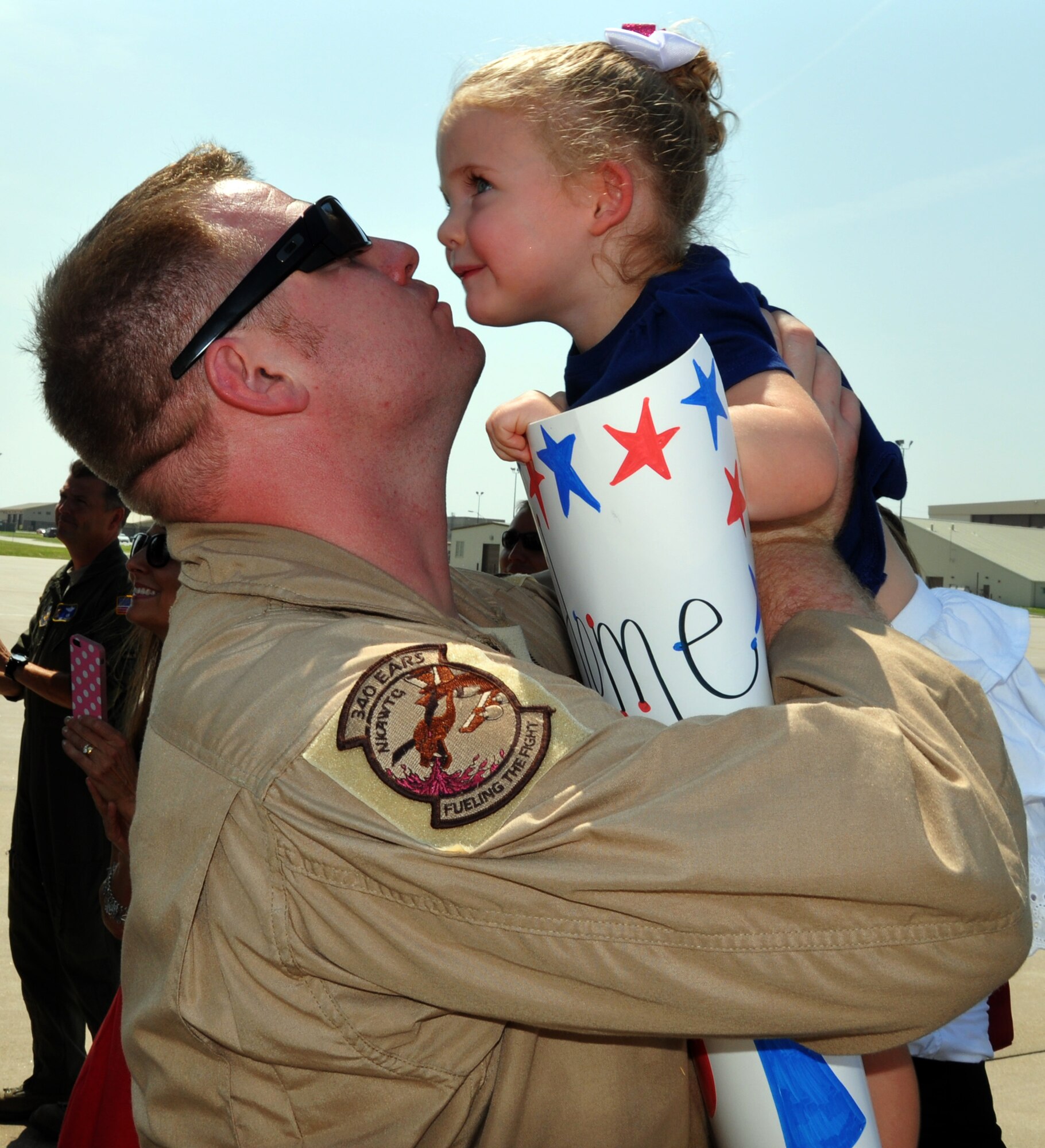 Master Sgt. Chris Norris, an Air Force Reservist assigned to the 931st Air Refueling Group, greets his daughter upon his return home to McConnell Air Force Base, Kan., July 21, 2014.  Norris had served a 60-day deployment to Al Udeid Air Base, Qatar, as part of the 379th Air Expeditionary Wing.  (U.S. Air Force photo by Capt. Zach Anderson)      