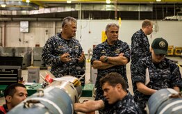 Cmdr. Charles Phillip, Naval Munitions Command commander (left), and Capt. Timothy Sparks, Joint Base Charleston deputy commander, observe NMC minemen as they conduct an exercise in the Navy Munitions Command mine shop, July 16, 2014, at JB Charleston, S.C. The Sailors in the mine shop routinely conduct drills and exercises to maintain their qualifications so they will be ready to deploy if necessary. (U.S. Air Force photo by Senior Airman Dennis Sloan)