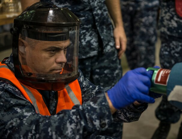 Master Chief Petty Officer Abel Fernandes, a reservist from New Jersey, spent his annual two-week training at the Navy Munitions Command mine shop, during an exercise July 16, 2014, at Joint Base Charleston, S.C. The active-duty Sailors in the mine shop are in a deployable status and ready to report to the fleet at any time, where they will maintain and deploy mines aboard aircraft carriers. (U.S. Air Force photo by Senior Airman Dennis Sloan)