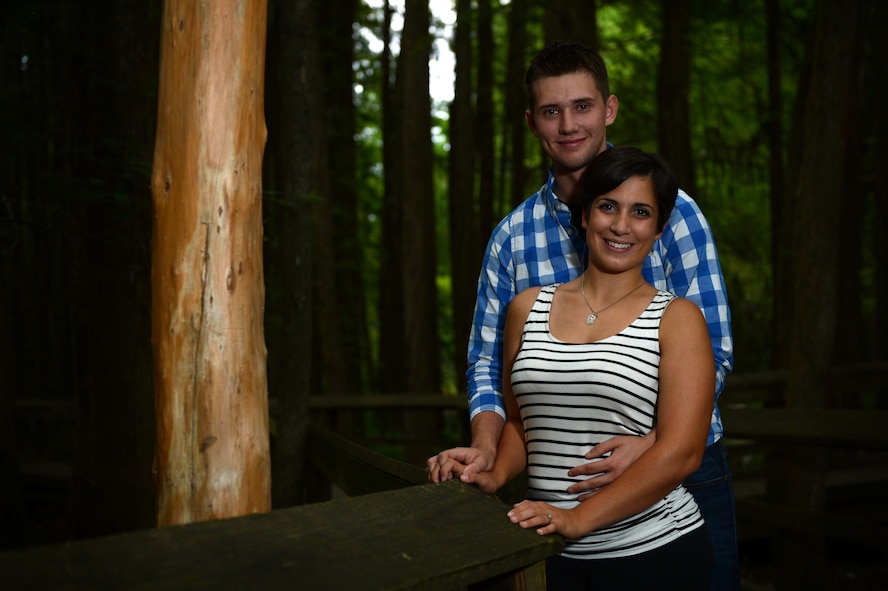 U.S. Air Force Airmen 1st Class, Michael and Diana Cossaboom, 20th Fighter Wing Public Affairs photojournalists, stand on a bridge at Swan Lake and Iris Gardens near Shaw Air Force Base, S.C., July 19, 2014. The Cossabooms participated in a six week marriage mentorship program created by Chaplain (Maj.) Richard Holmes, 20th FW interim deputy wing chaplain, which helped the two learn about their “love languages”. (U.S. Air Force photo by Airman 1st Class Jensen Stidham/Released)